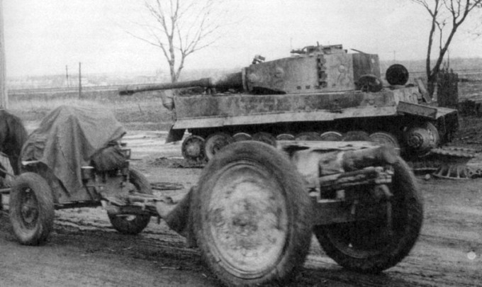 Soviet regiment cannon model 1927 moves near broken Tiger-I panzer